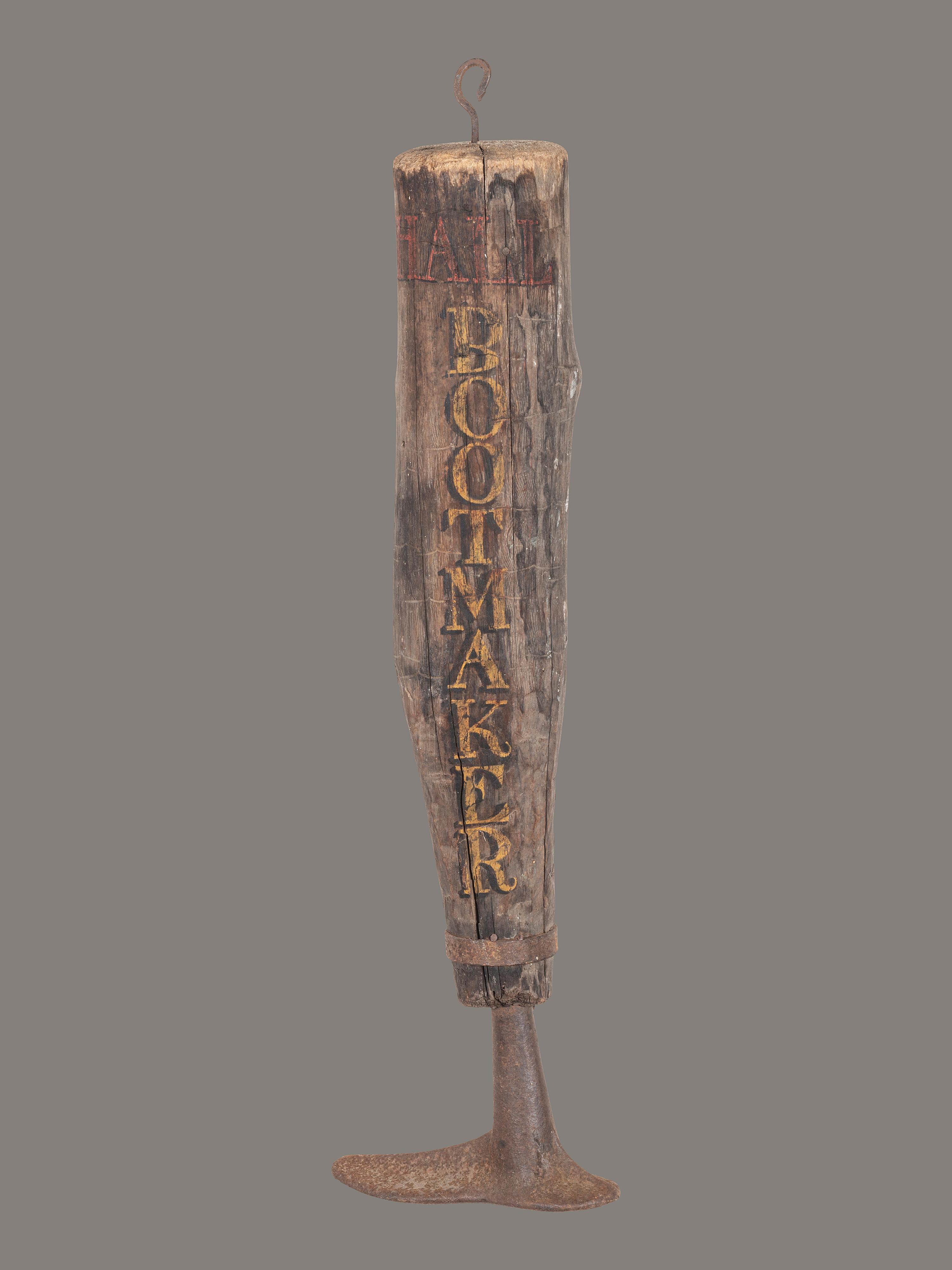 A Carved and Painted Wood and Iron Bootmaker Shop Sign