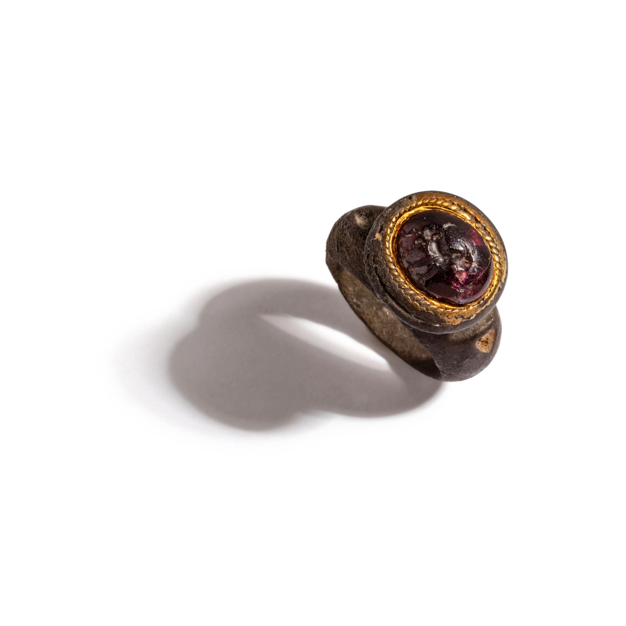 A Roman Gilt-Silver and Garnet Finger Ring with a Ram