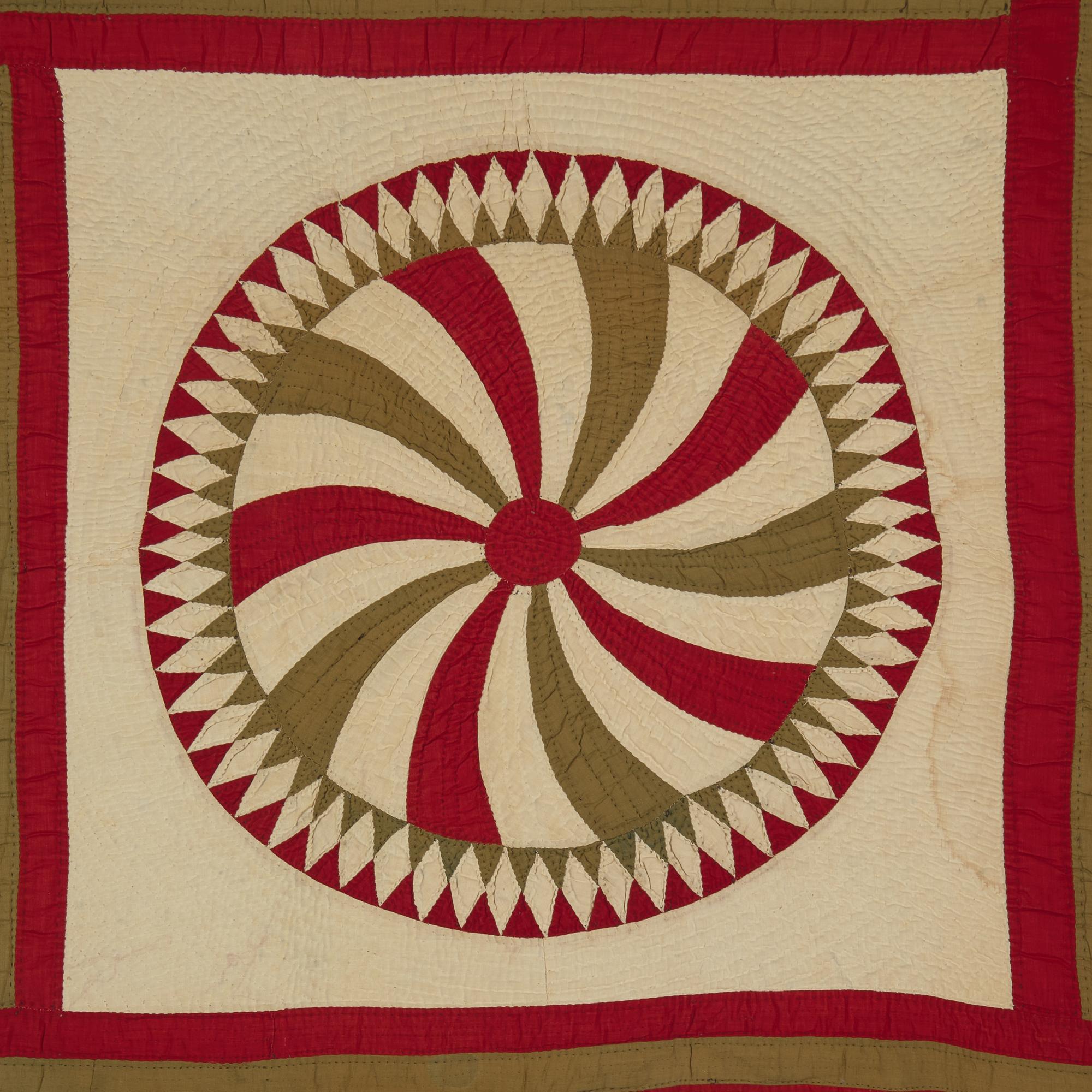 A Pieced Cotton Red and Gold Pinwheel Quilt