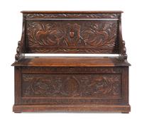An Italian Renaissance Revival Carved Oak Settle