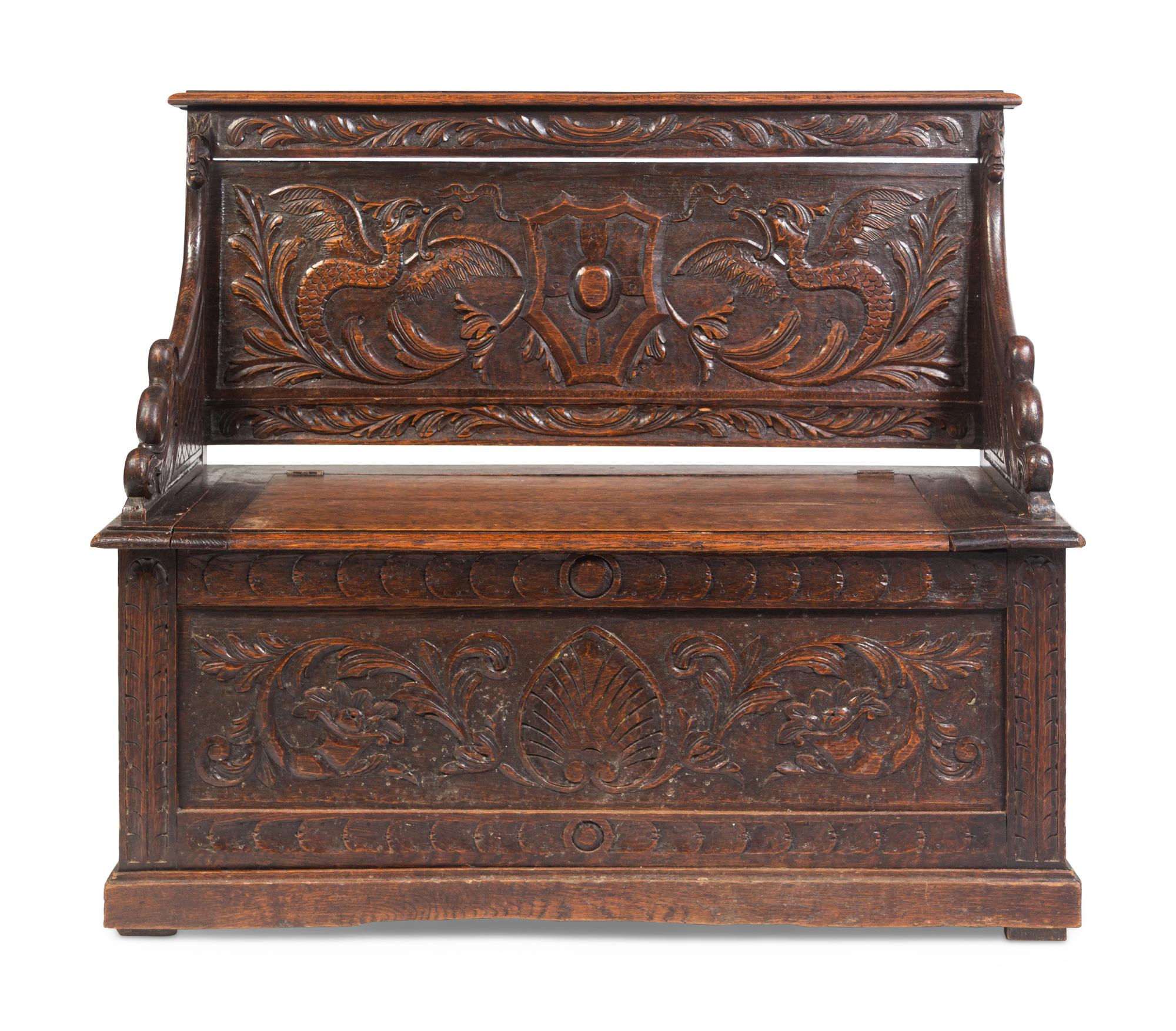 An Italian Renaissance Revival Carved Oak Settle