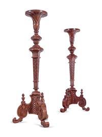 A Pair of Continental Carved Walnut Torchères
