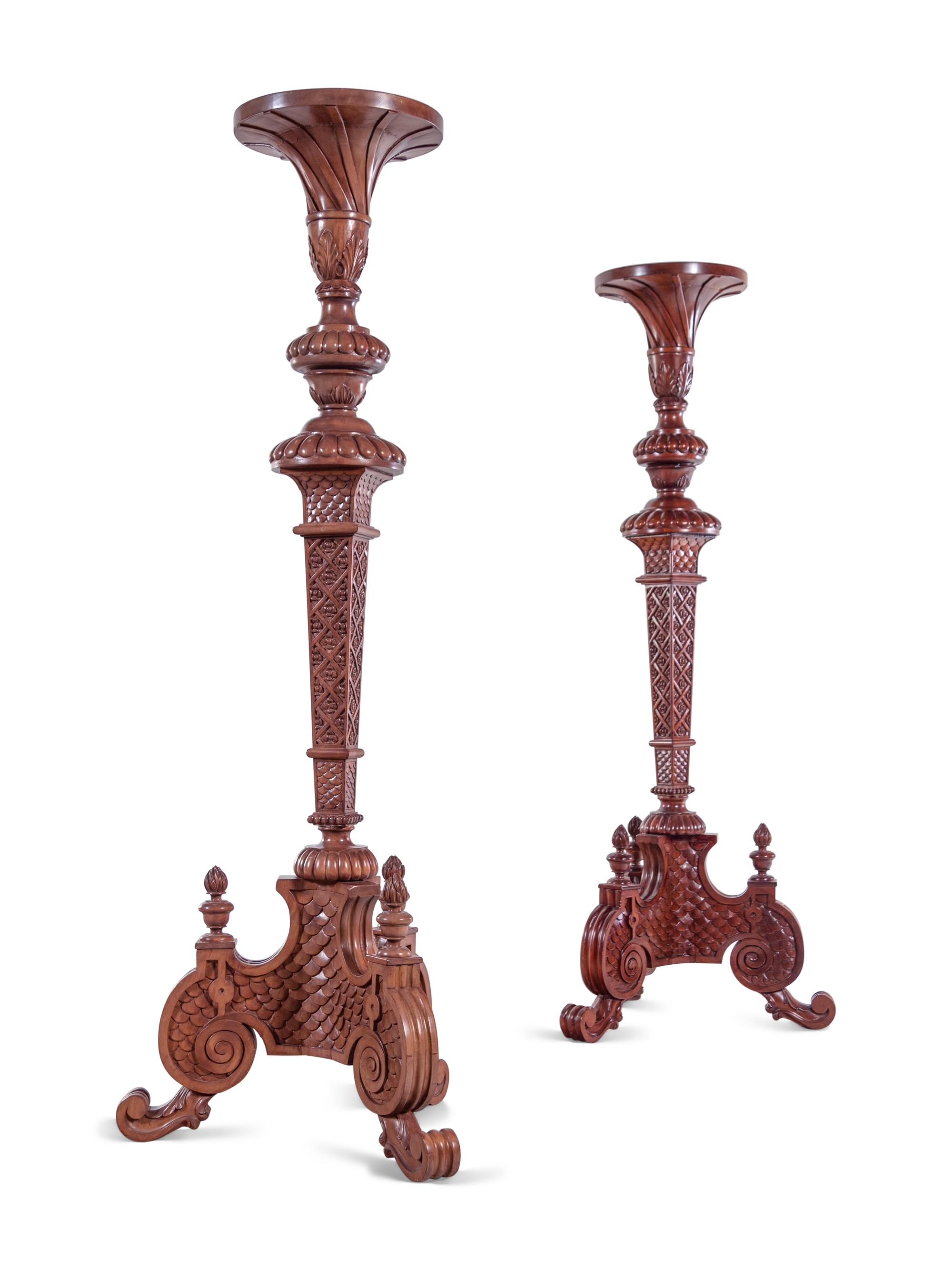 A Pair of Continental Carved Walnut Torchères