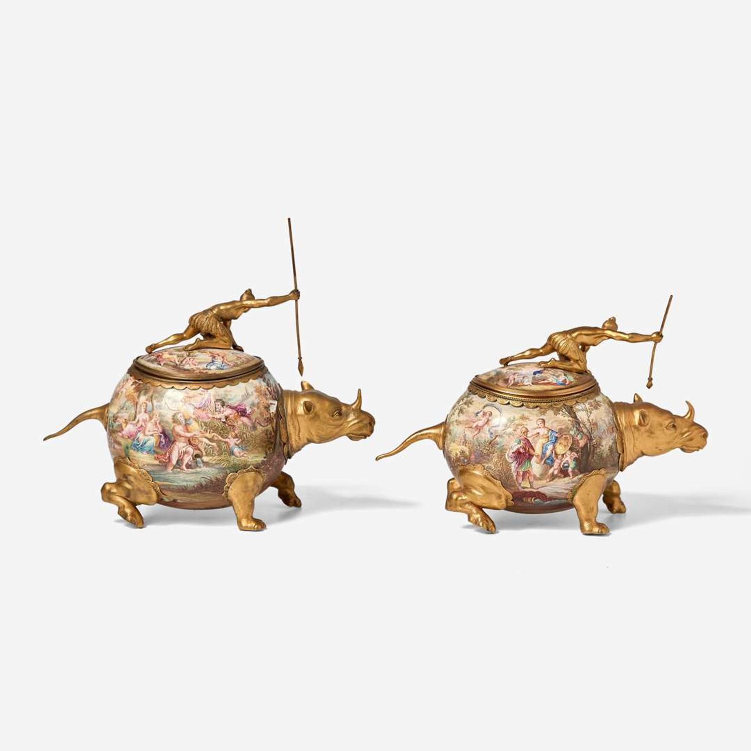 A pair of gilt metal and enamel covered vessels in the form of hunters riding rhinoceros Probably Vienna, Austria, late 19th century