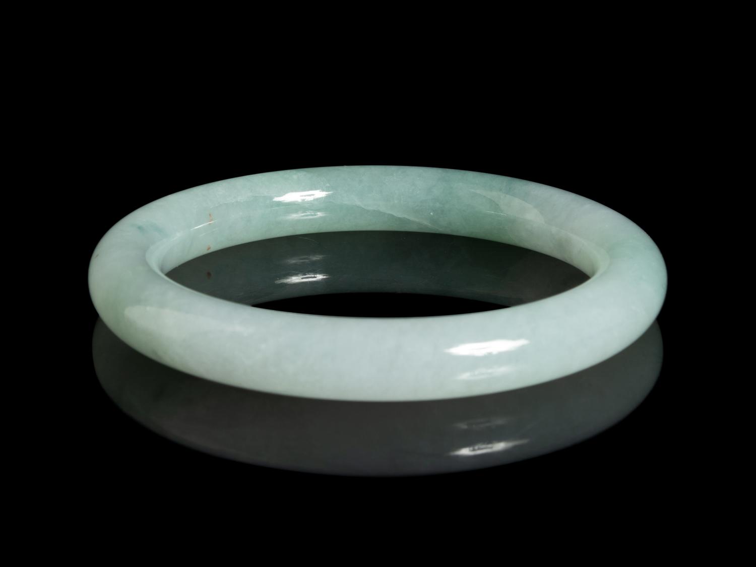 A Chinese Apple Green and Pale Celadon Jadeite Bangle