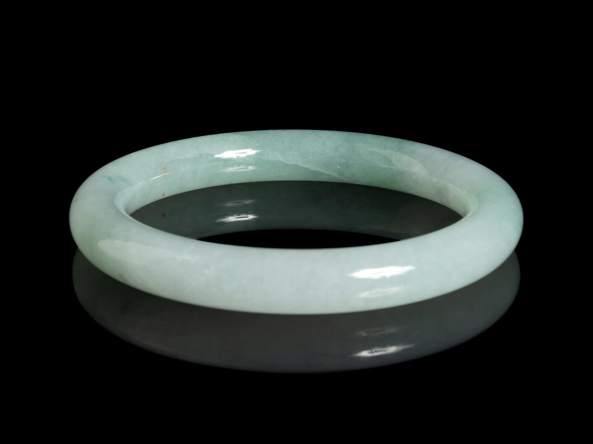 A Chinese Apple Green and Pale Celadon Jadeite Bangle