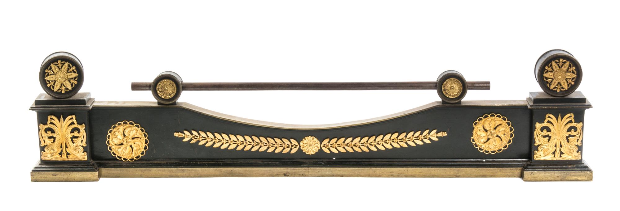 An Empire Gilt and Patinated Bronze Fire Guard, Width 39 inches.