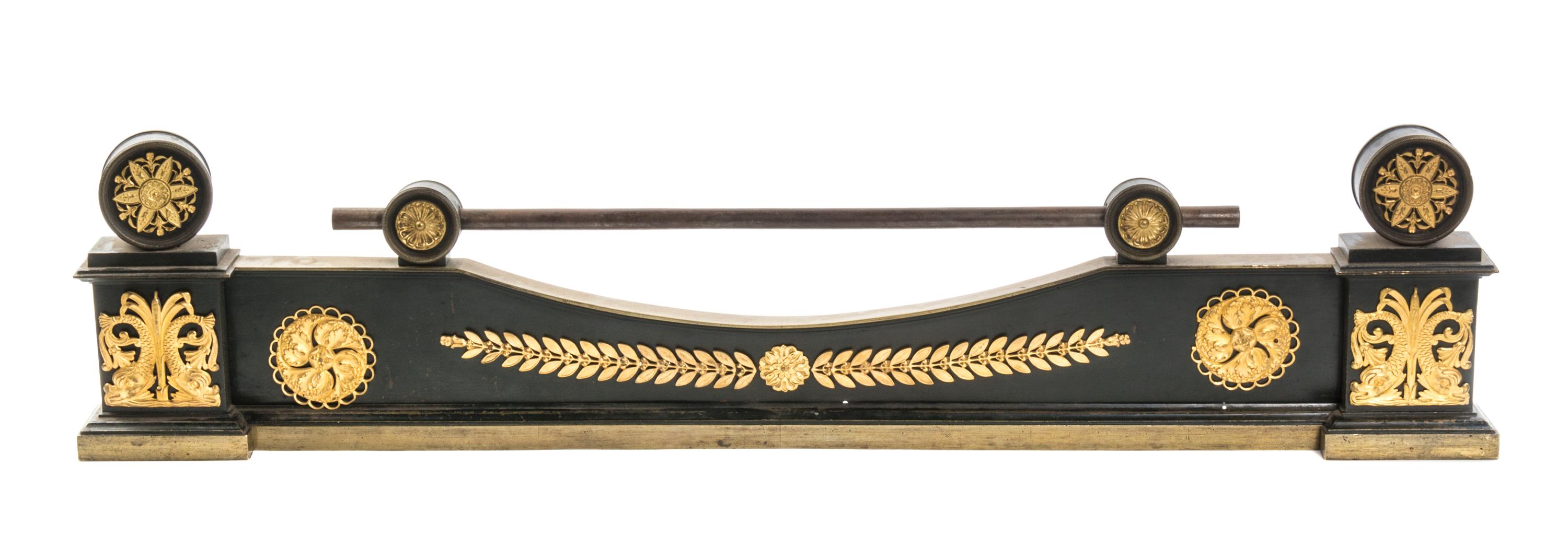 An Empire Gilt and Patinated Bronze Fire Guard, Width 39 inches.