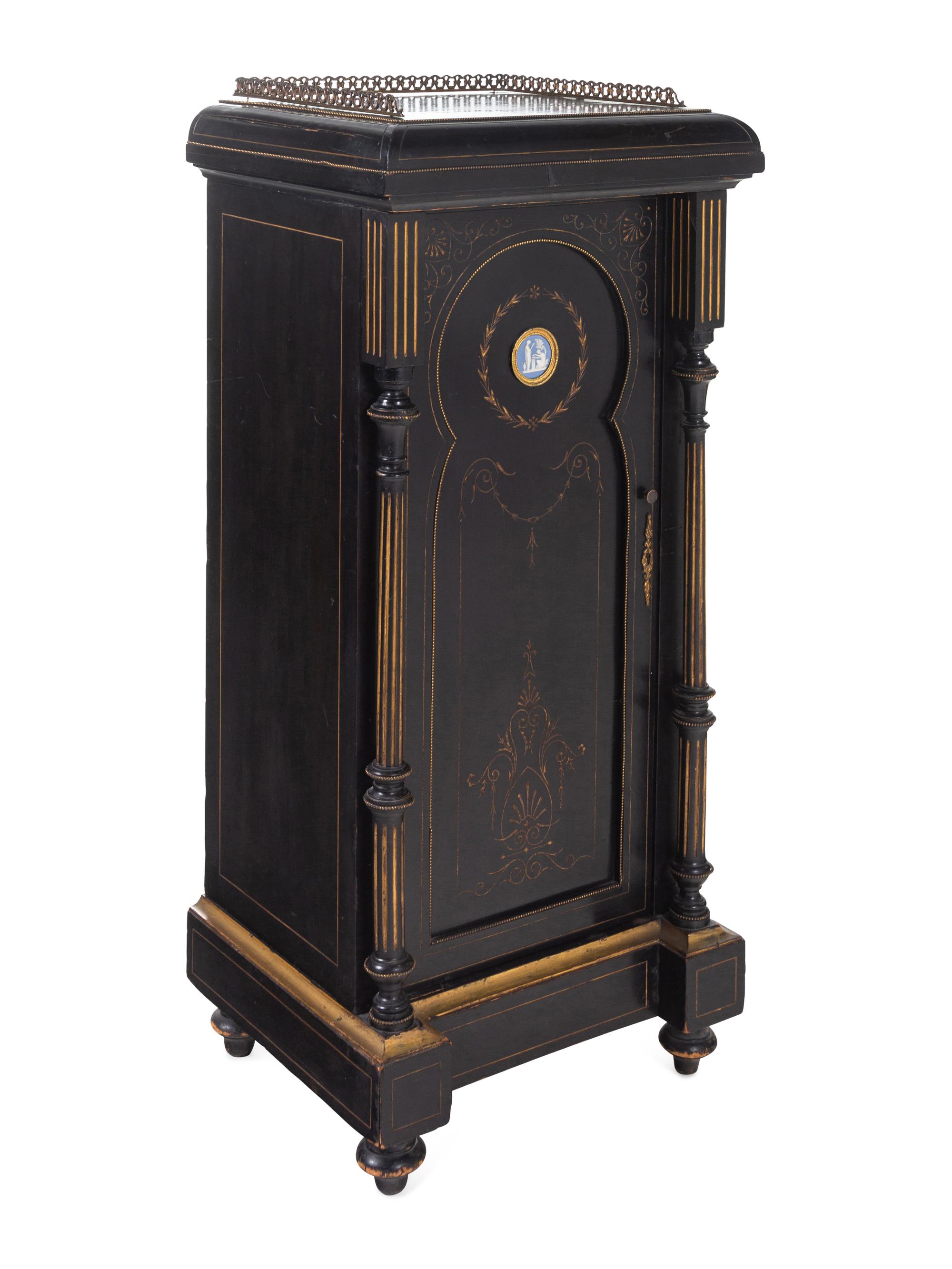 A Pair of English Aesthetic Jasperware Medallion-Mounted Ebonized and Parcel-Gilt Pedestal Cabinets