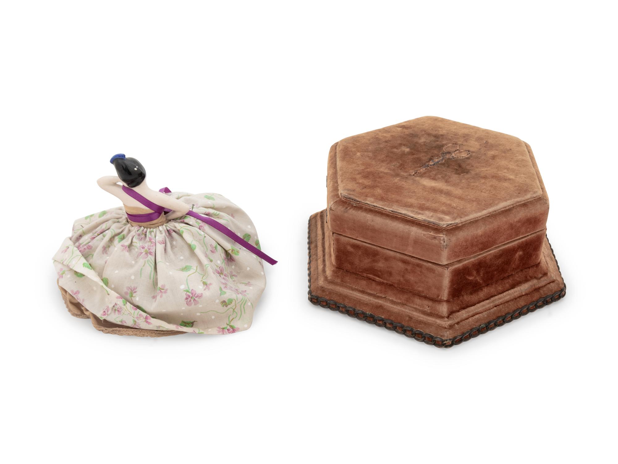 A Velvet-Clad Needlework Box, a Porcelain "Doll" Pin Cushion and a Collection of Thimble Cases