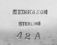 An American Silver Center Bowl, S. Kirk & Son, Baltimore, MD, the undulating rim formed of S-scrolls spaced with rocaille above the flo