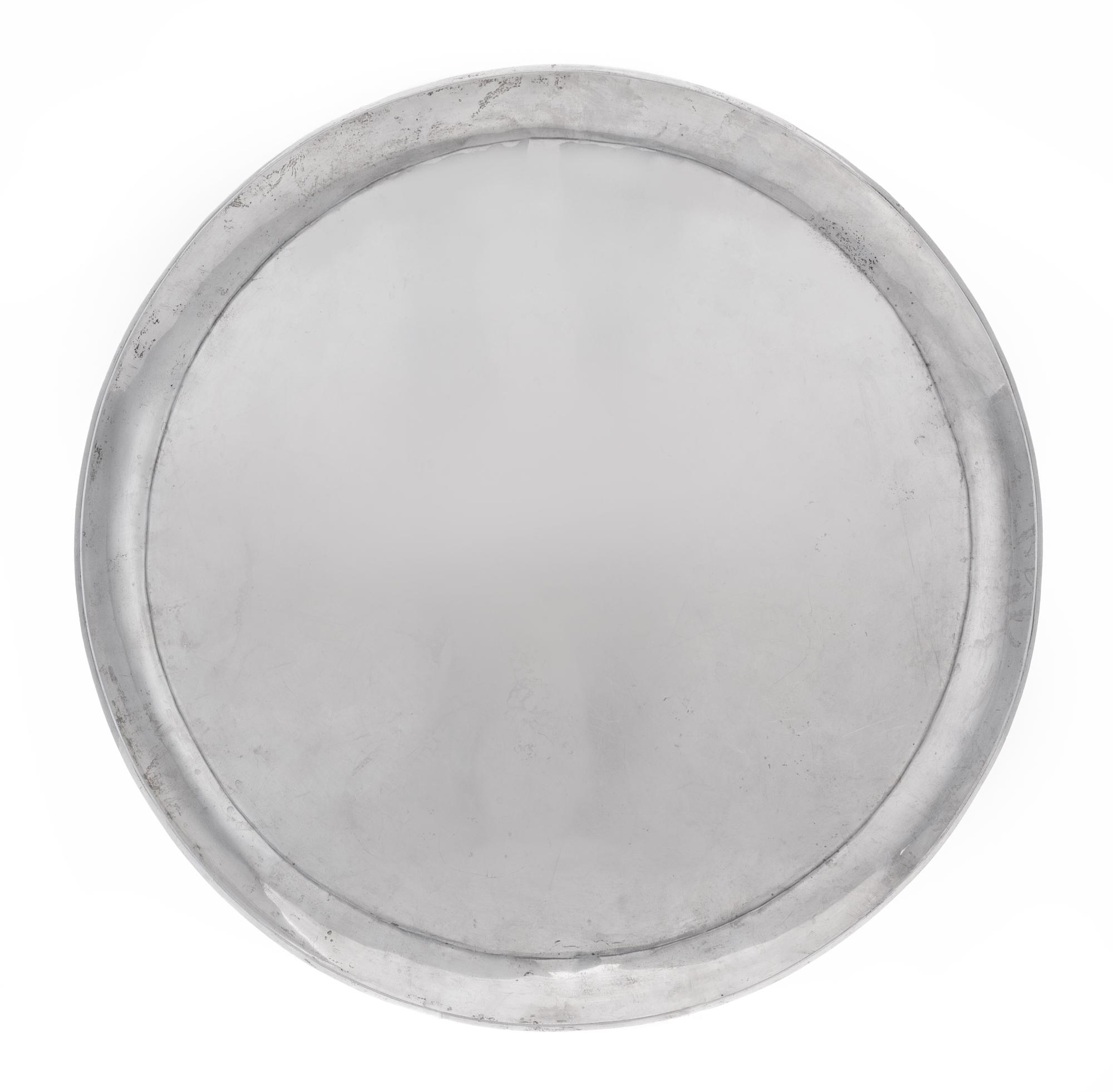 A Mexican Silver Tray, 20th Century, of circuar form.
