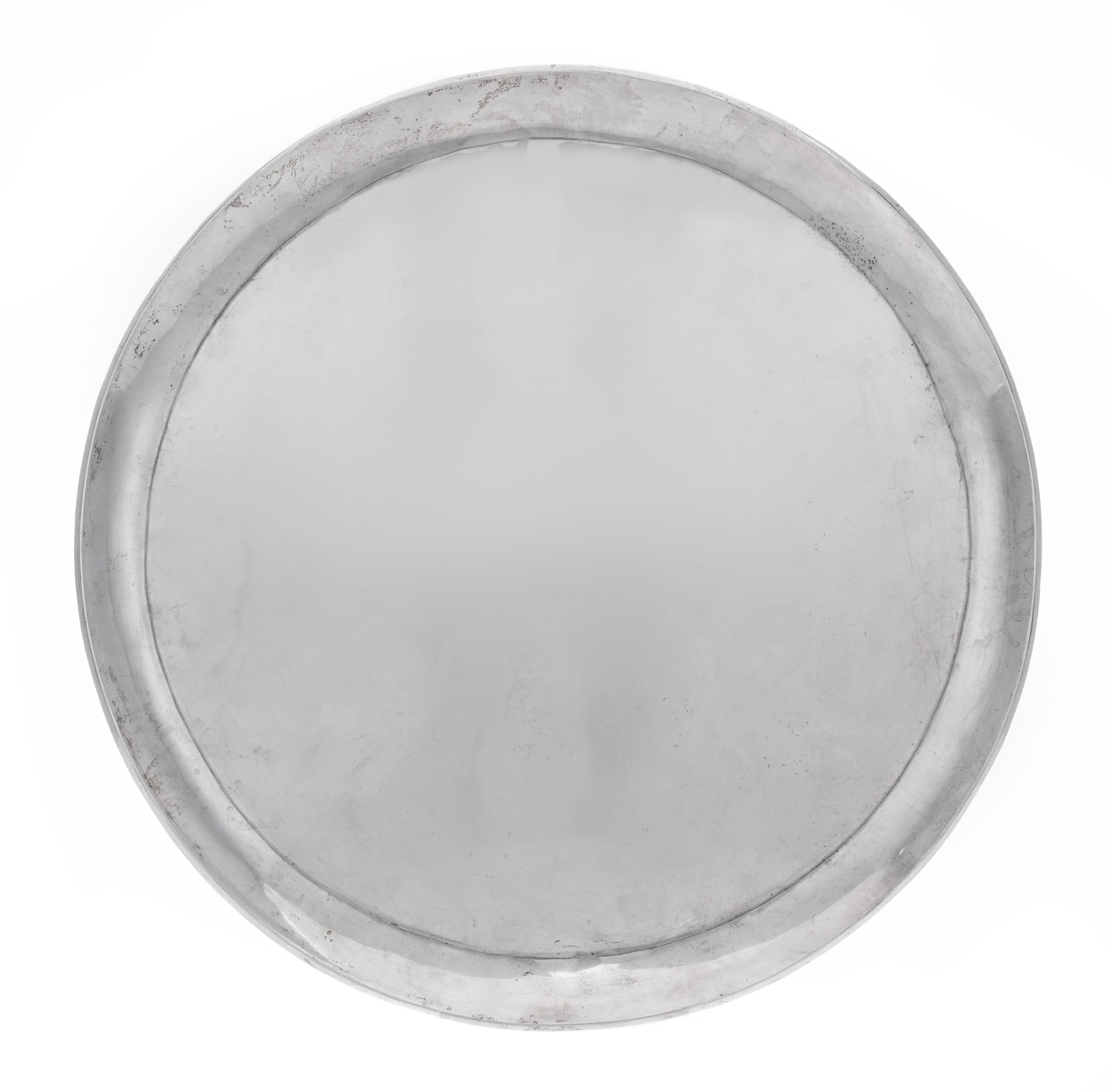 A Mexican Silver Tray, 20th Century, of circuar form.