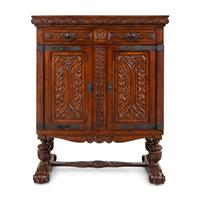 A Baroque Style Carved Walnut and Steel Mounted Cabinet