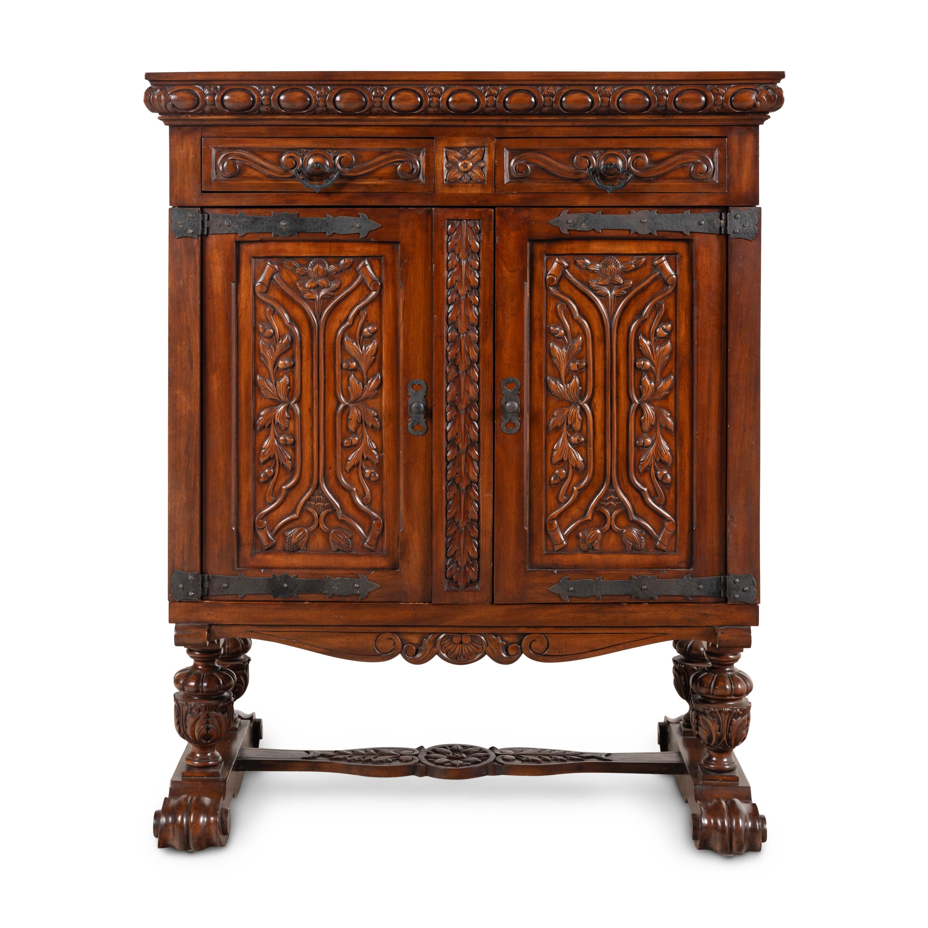 A Baroque Style Carved Walnut and Steel Mounted Cabinet