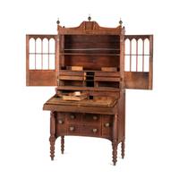 A Classical Figured Maple and Mahogany Desk-and-Bookcase