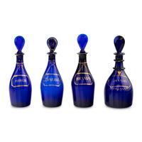 A Group of Four Cobalt Glass and Gilt Decorated Decanters