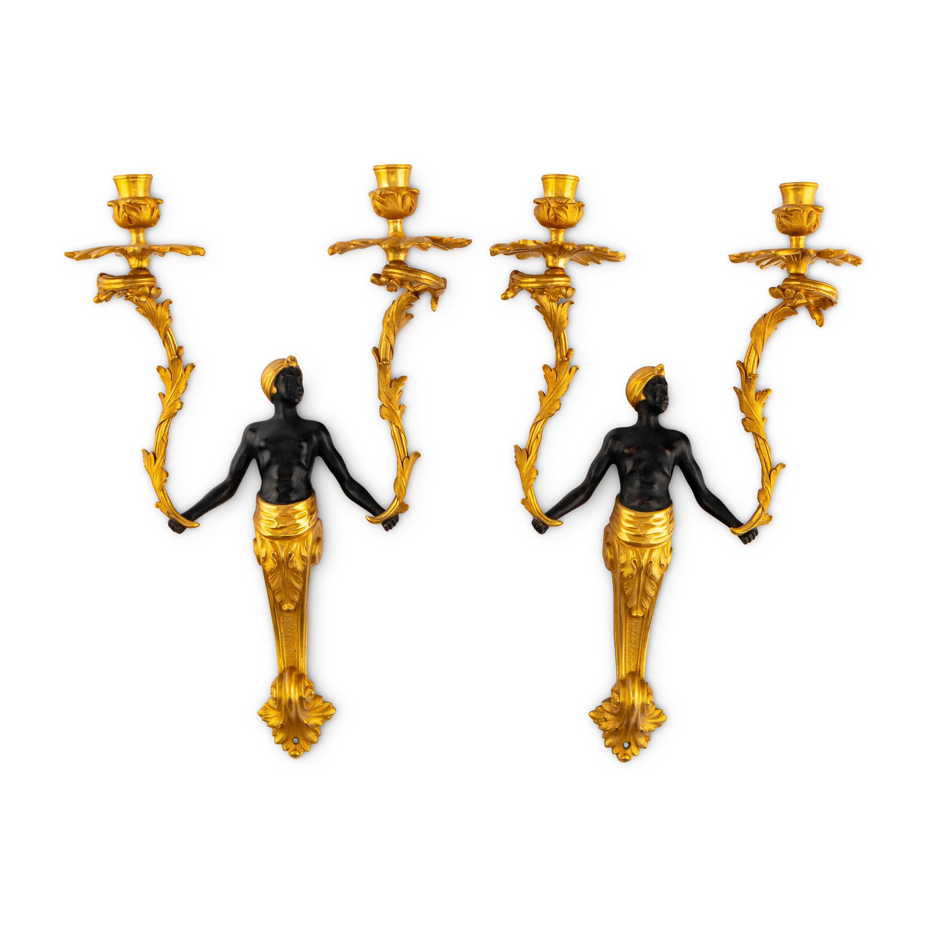 A Pair of French Gilt and Patinated Bronze Figural Two-Light Sconces