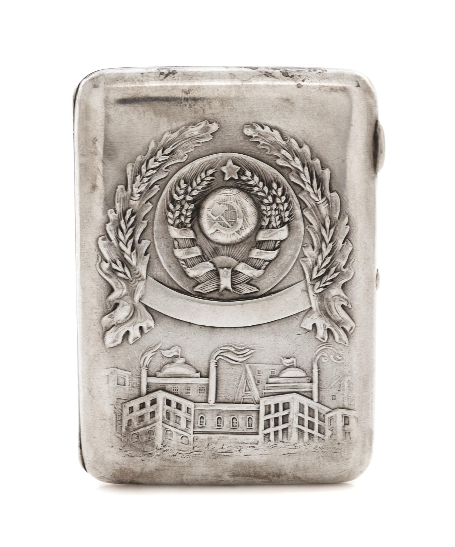 A Russian Silver Cigarette Case, Retailed by Mostorg, Moscow, 20th century, the lid worked with the seal of the Soviet Union above an i