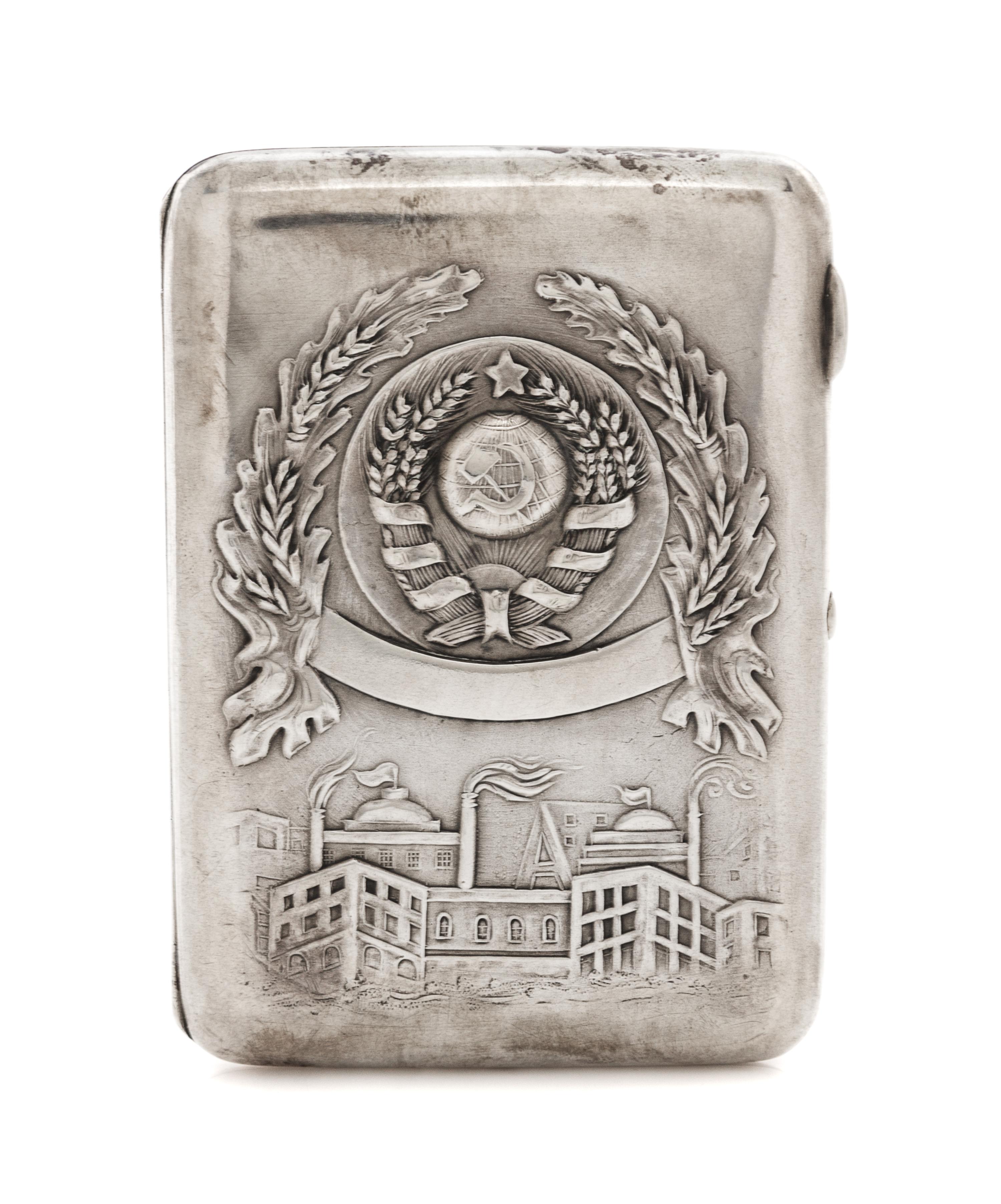 A Russian Silver Cigarette Case, Retailed by Mostorg, Moscow, 20th century, the lid worked with the seal of the Soviet Union above an i