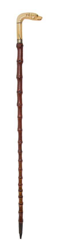 An Austrian Carved Walrus Ivory Handled Cane, Width of handle 3 1/2 x length overall 33 1/2 inches.