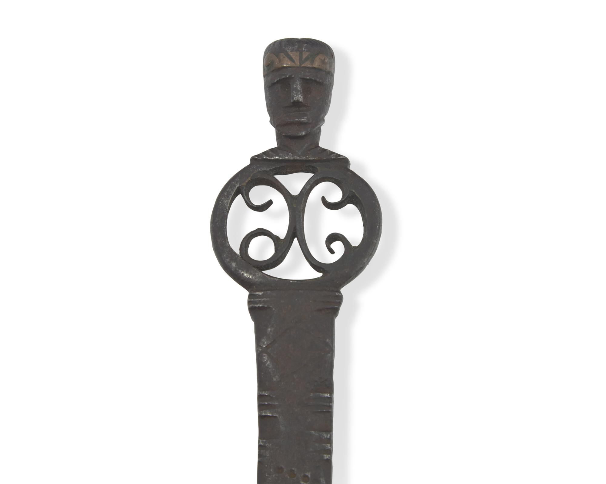 A Copper-Inlaid Wrought Iron Slotted Spoon with Human Head-Form Terminals