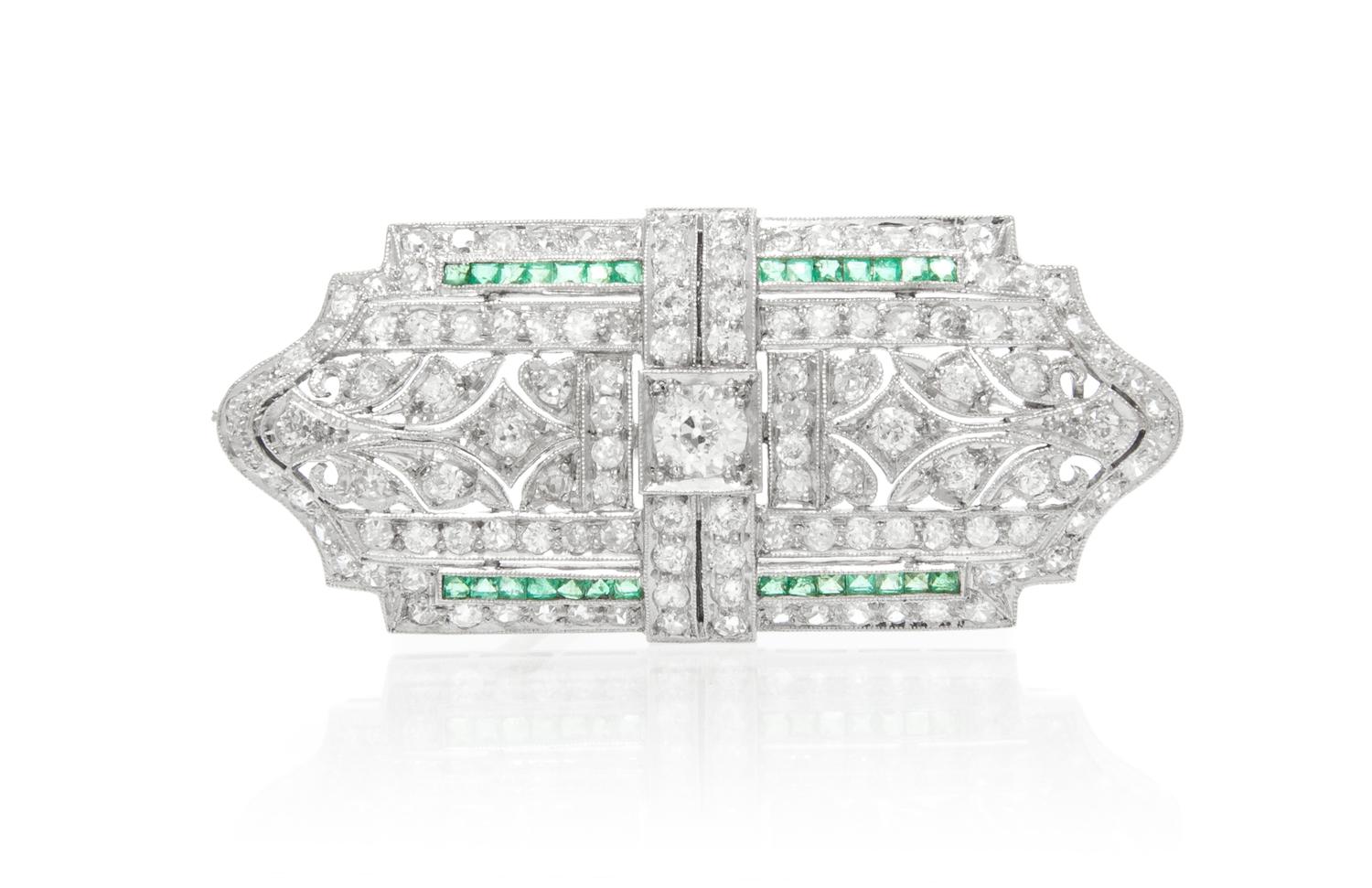 An Art Deco Platinum, Diamond and Emerald Brooch, 7.70 dwts.