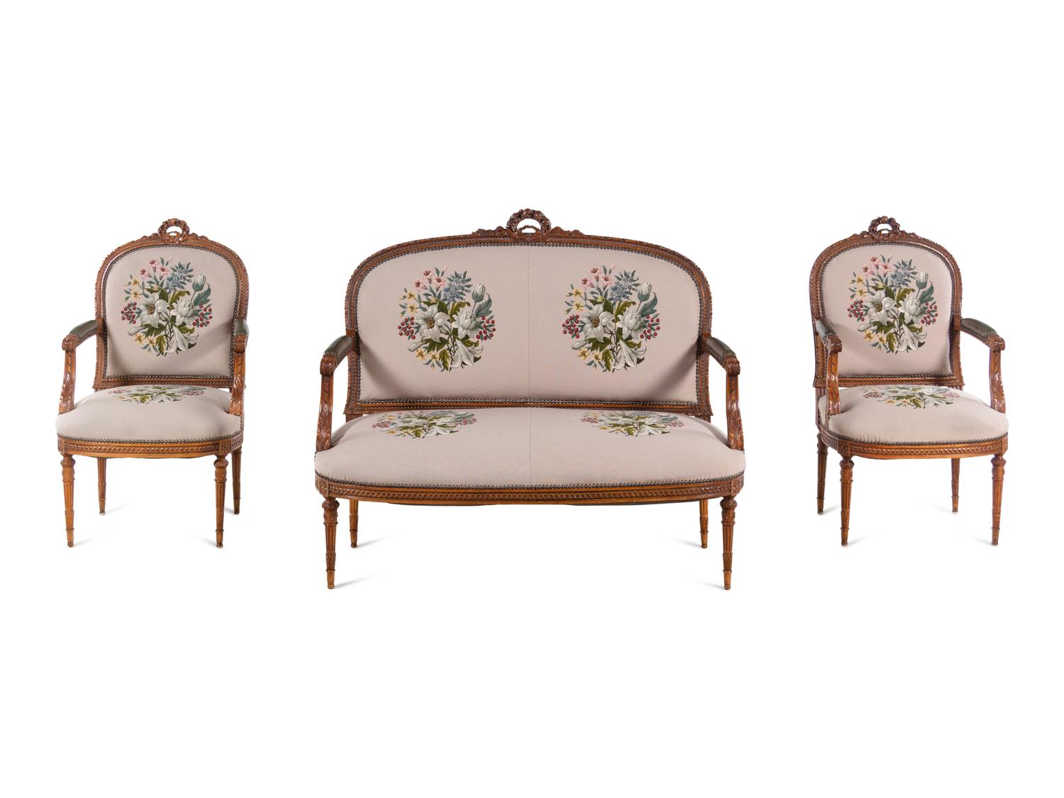 A Louis XVI Carved Walnut Seating Suite with Petit Point Upholstery