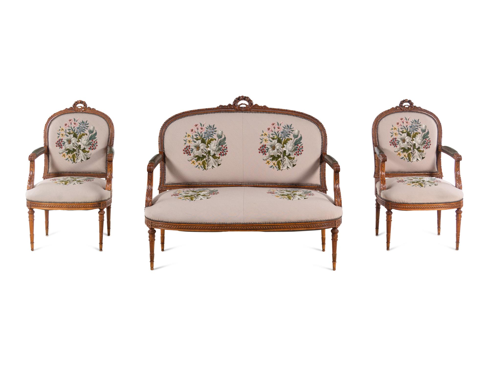 A Louis XVI Carved Walnut Seating Suite with Petit Point Upholstery