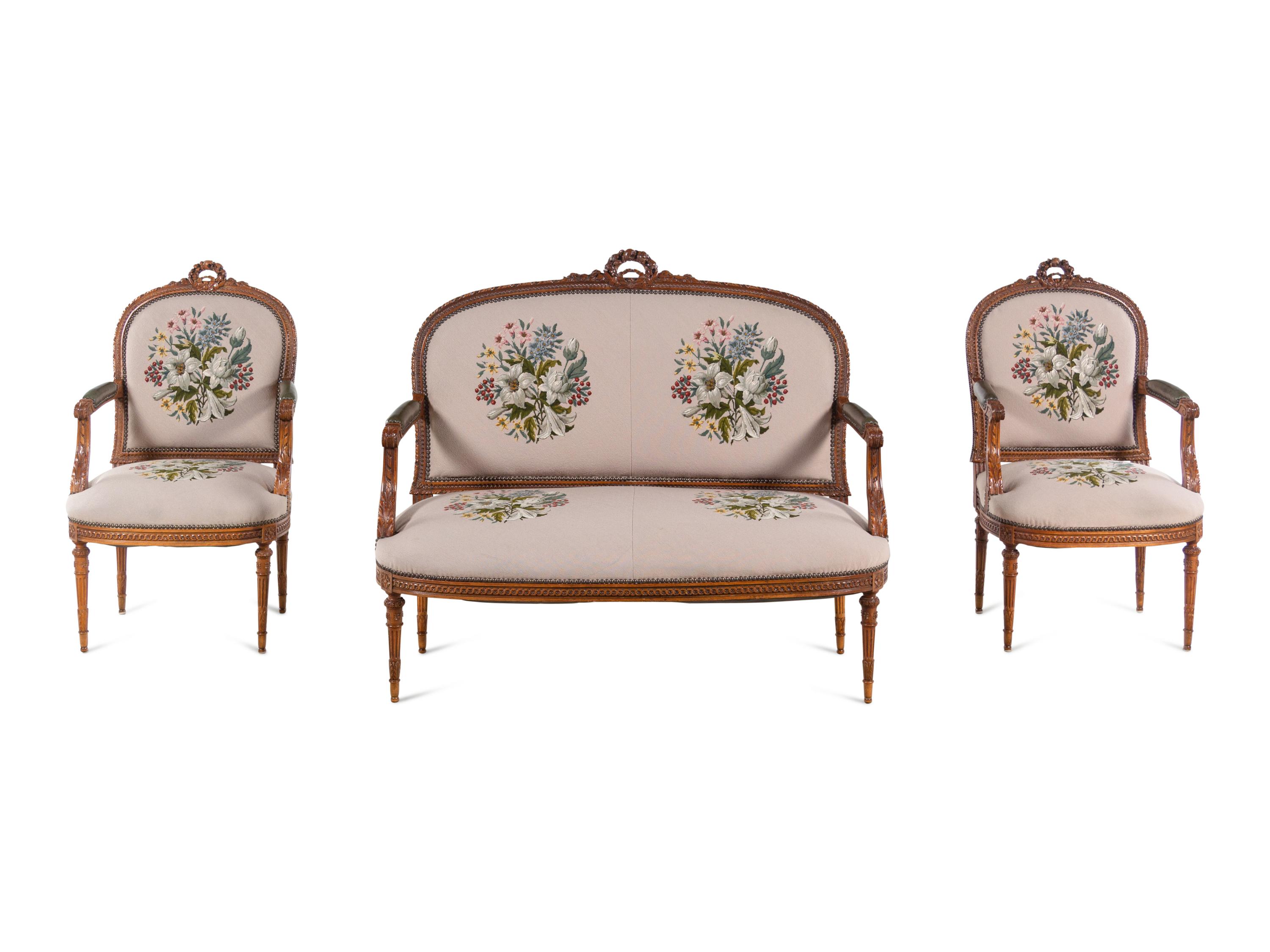 A Louis XVI Carved Walnut Seating Suite with Petit Point Upholstery