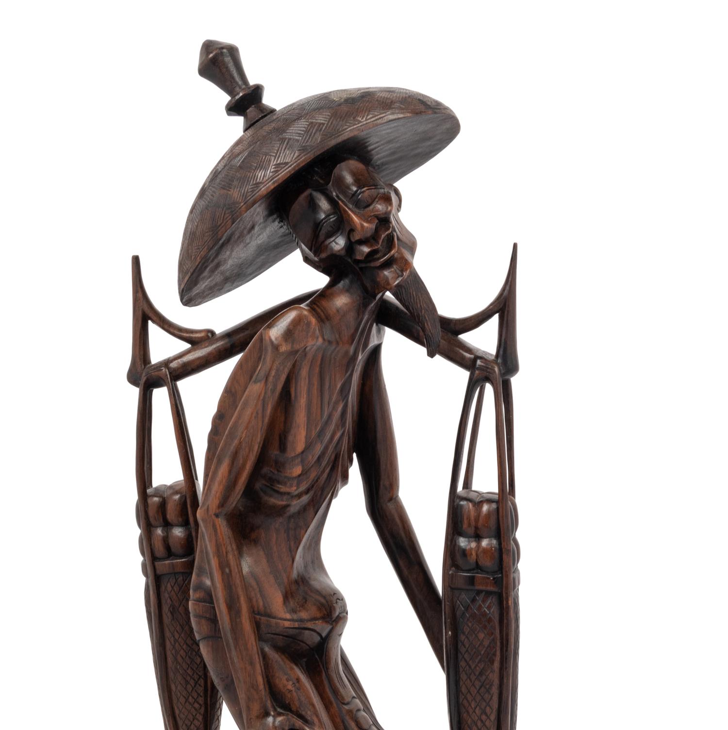 A Carved Wood Figure of a Water Carrier