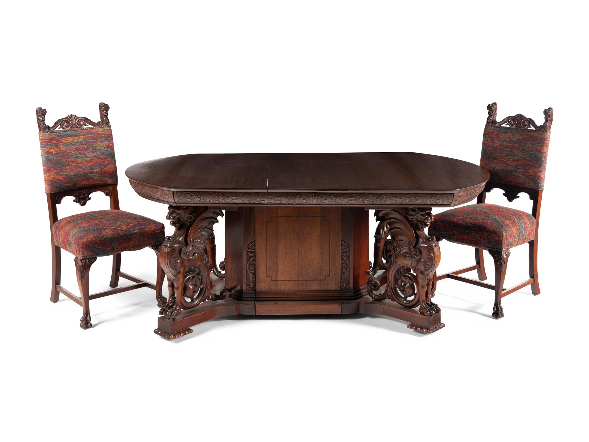 A Renaissance Revival Carved Mahogany Dining Table and Set of Six Chairs