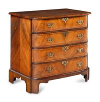 A George III Bookmatch-Veneered Bowfront Chest of Drawers