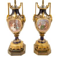 A Pair of Sevres Style Gilt Bronze Mounted Porcelain Urns Height 15 1/2 inches.
