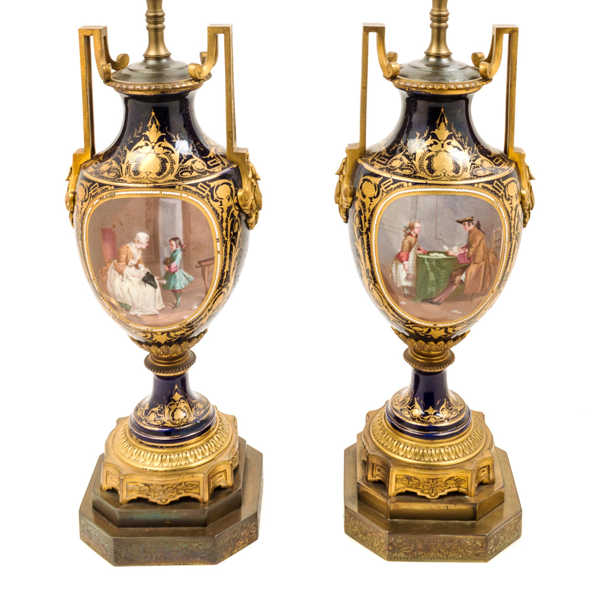 A Pair of Sevres Style Gilt Bronze Mounted Porcelain Urns Height 15 1/2 inches.