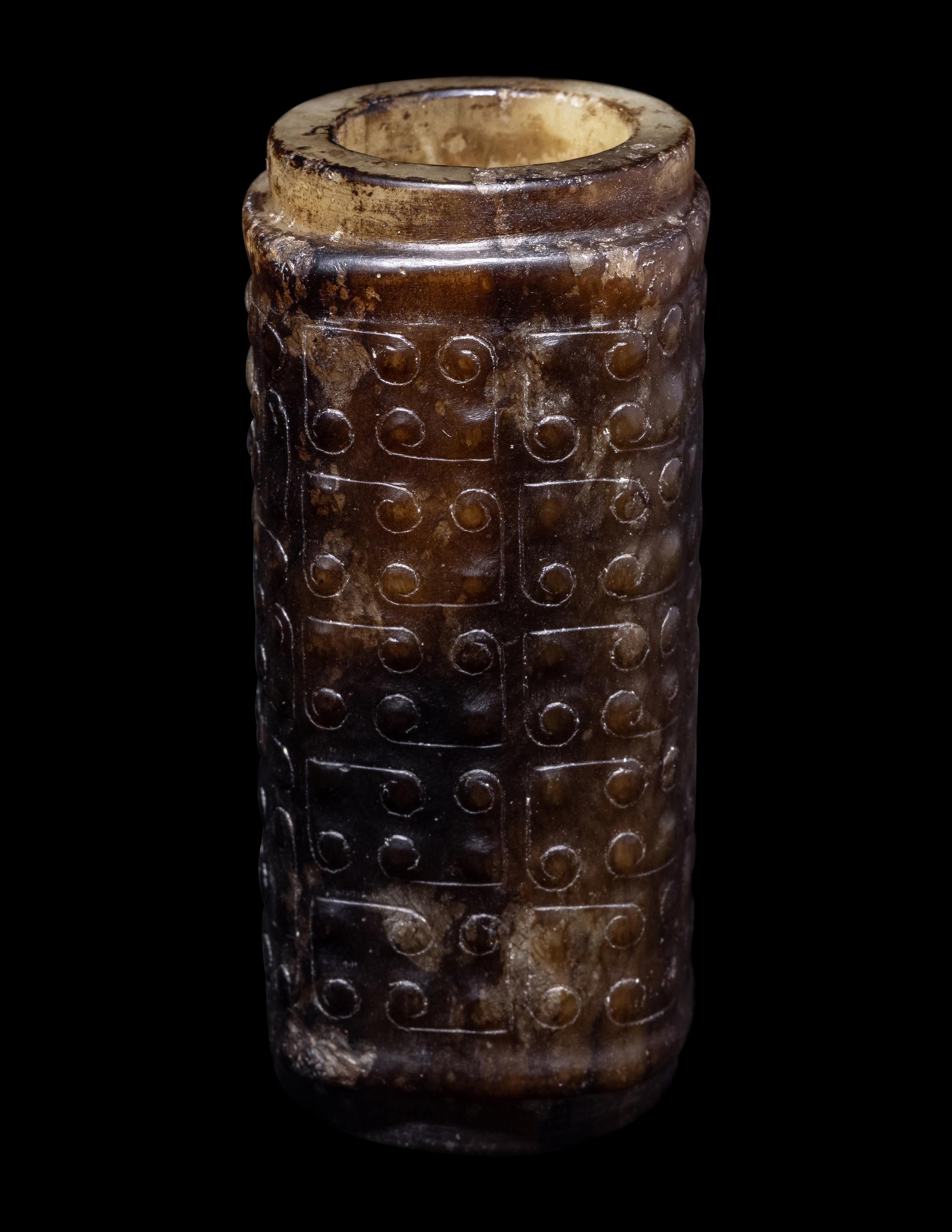 A Small Chinese Dark Russet and Celadon Jade Cong