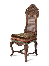A Set of Four William and Mary Style Caned and Pierced-Carved Walnut Dining Chairs