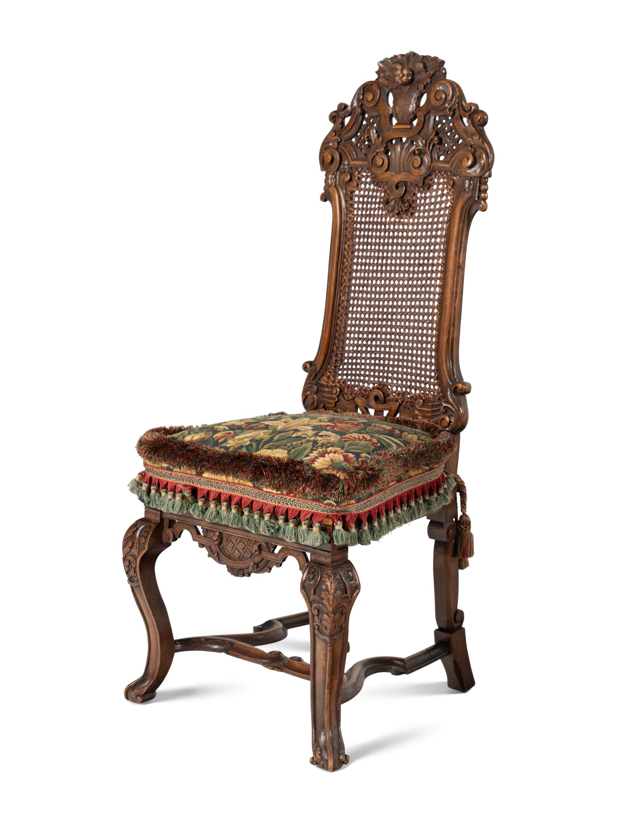 A Set of Four William and Mary Style Caned and Pierced-Carved Walnut Dining Chairs