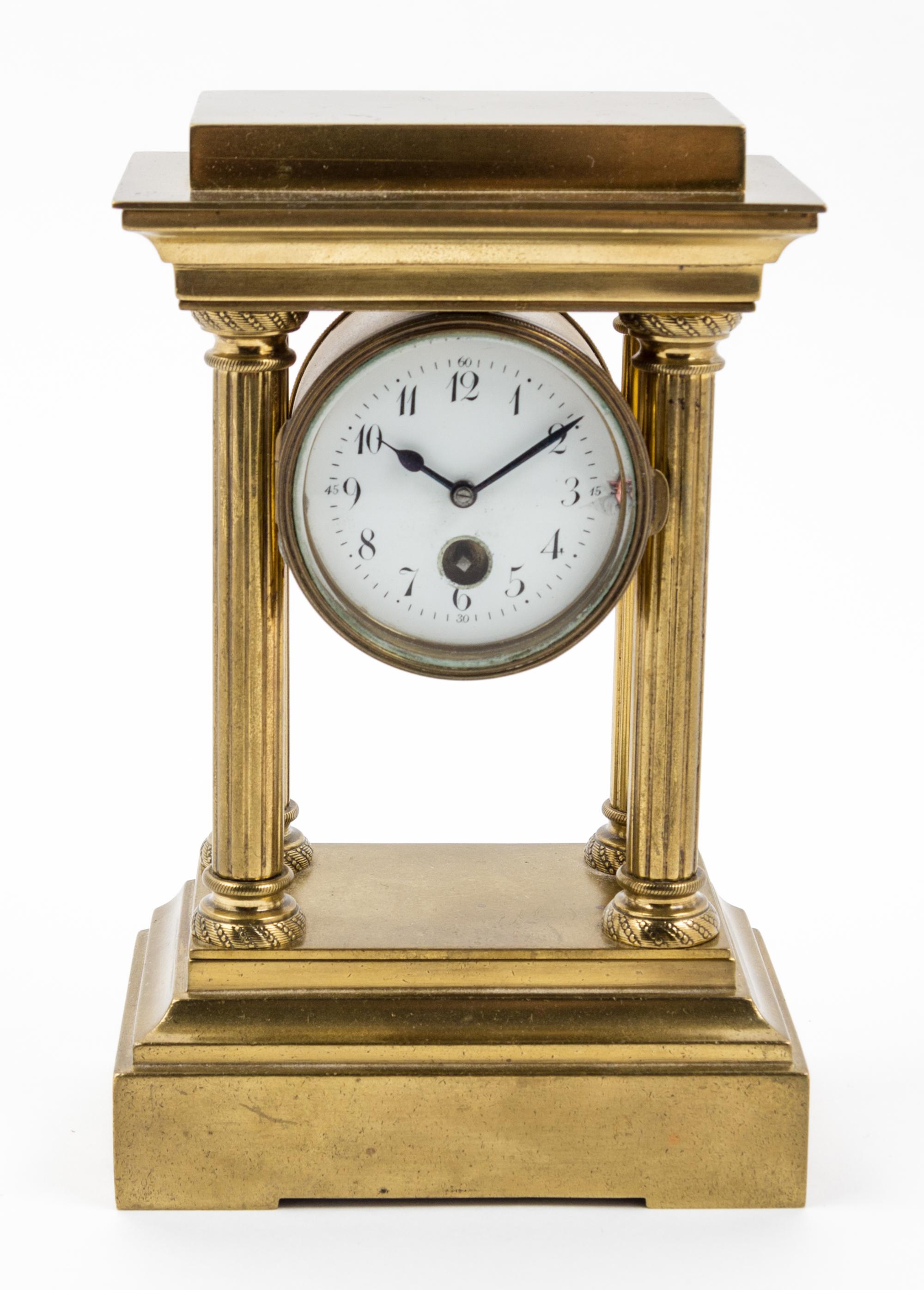 An Empire Style Brass Mantel Clock Height 7 inches.