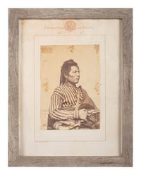 [NATIVE AMERICANS]. JACKSON, William Henry (1843-1942), photographer. Albumen photograph of Pawnee policeman and scout, Tu-Tuc-A-Picish-Te-Ruk, posed with Remington revolver.