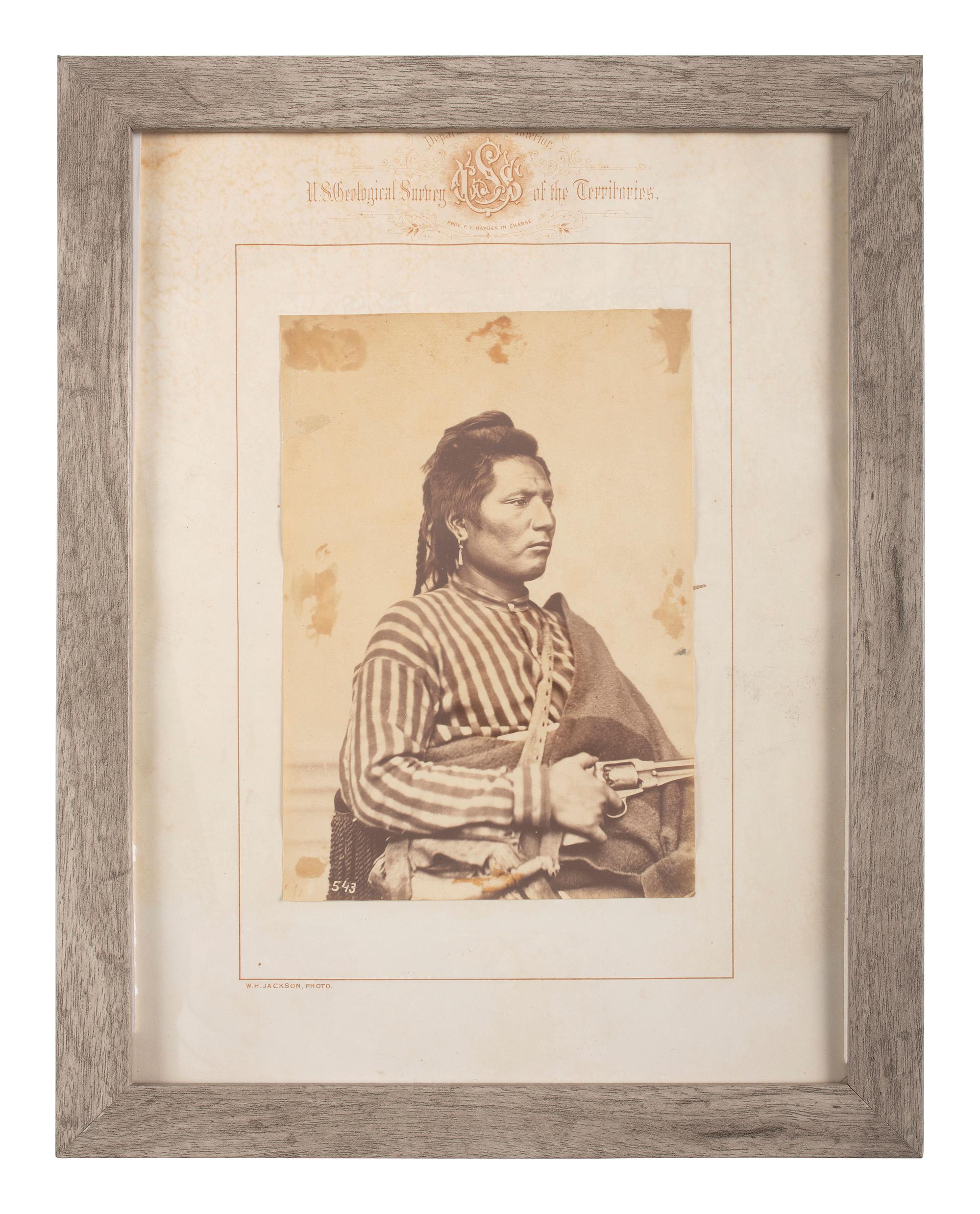[NATIVE AMERICANS]. JACKSON, William Henry (1843-1942), photographer. Albumen photograph of Pawnee policeman and scout, Tu-Tuc-A-Picish-Te-Ruk, posed with Remington revolver.
