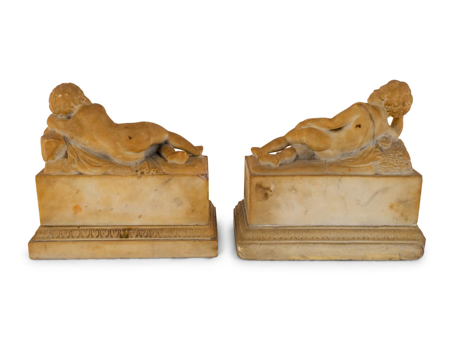A Pair of Marble Models of Sleeping Cherubs on Plinths