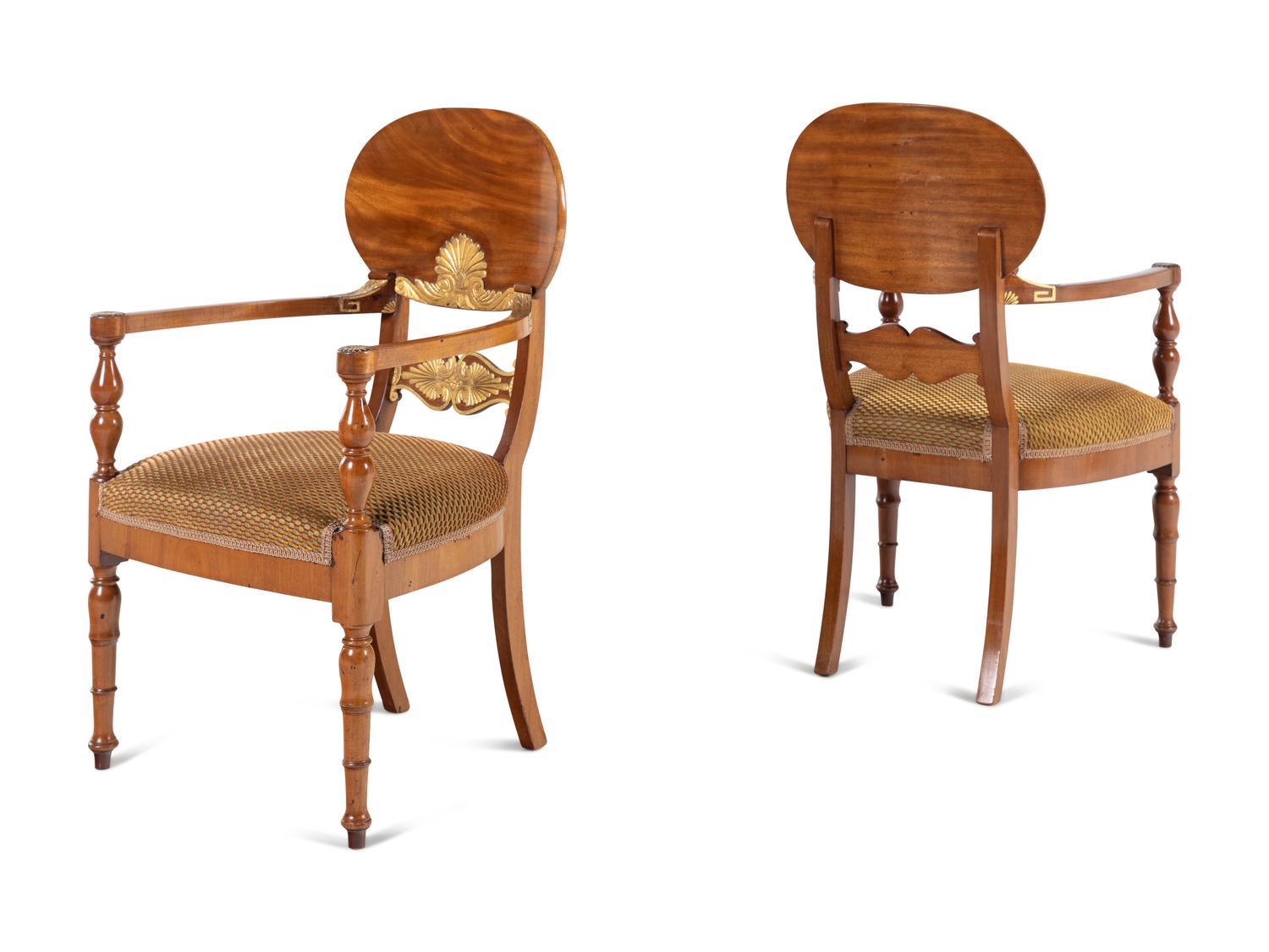 A Pair of Baltic Neoclassical Parcel-Gilt Walnut Armchairs