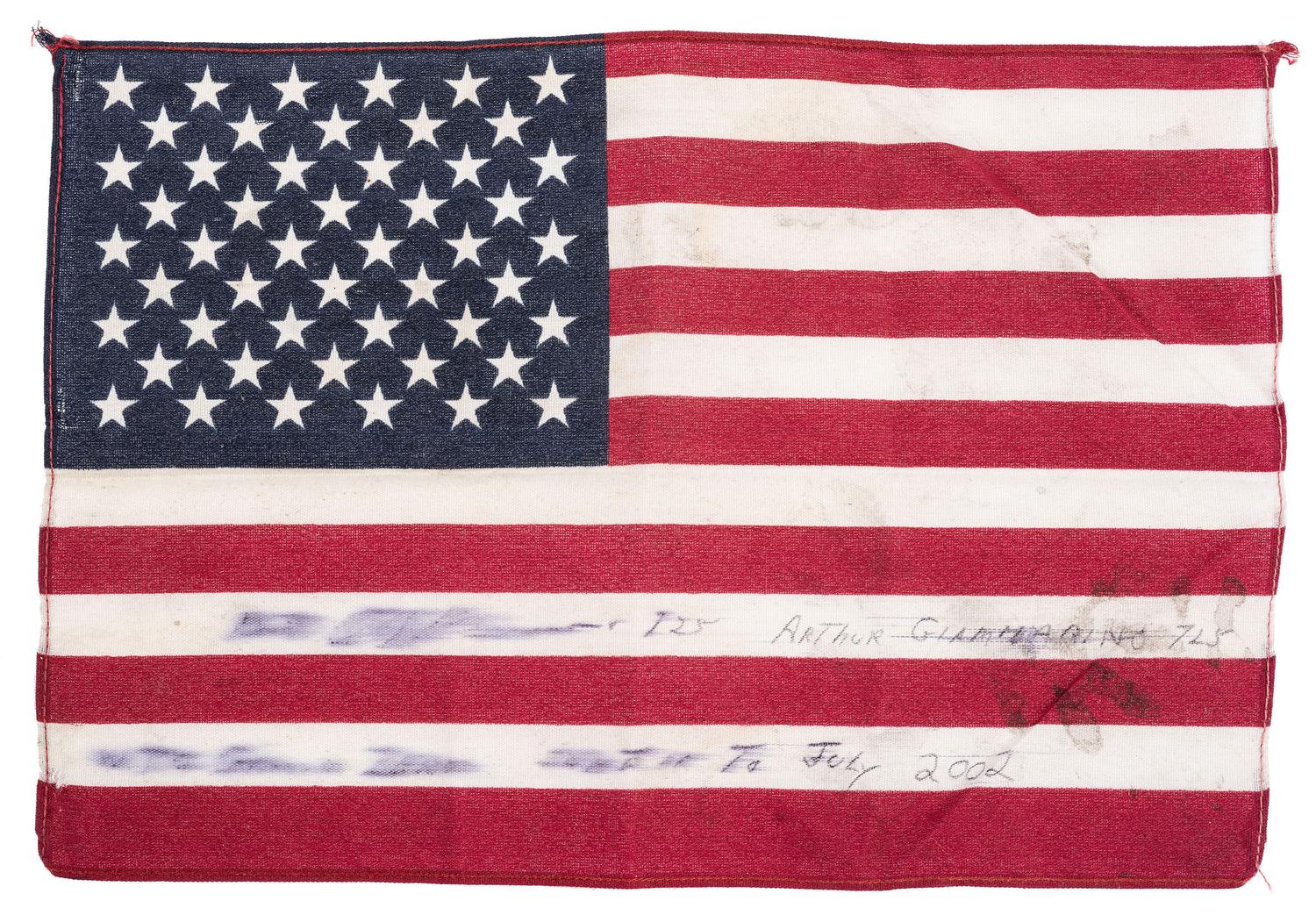 [FLAGS]. A group of items related to the recovery efforts at Ground Zero after September 11, 2011, incl. a helmet worn at the site by retired NYC Detective Arthur Giammarino as he assisted in the recovery efforts.