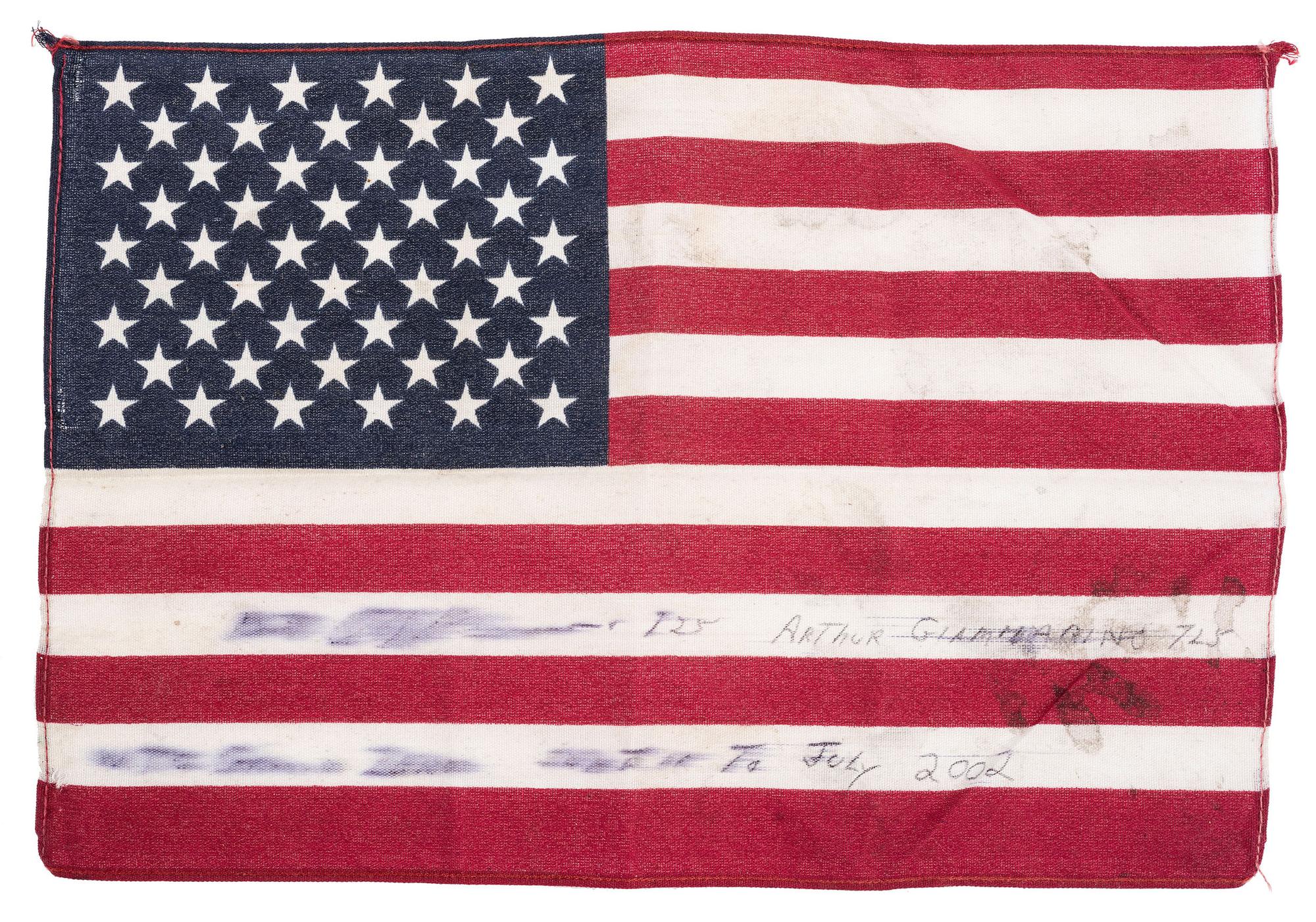 [FLAGS]. A group of items related to the recovery efforts at Ground Zero after September 11, 2011, incl. a helmet worn at the site by retired NYC Detective Arthur Giammarino as he assisted in the recovery efforts.
