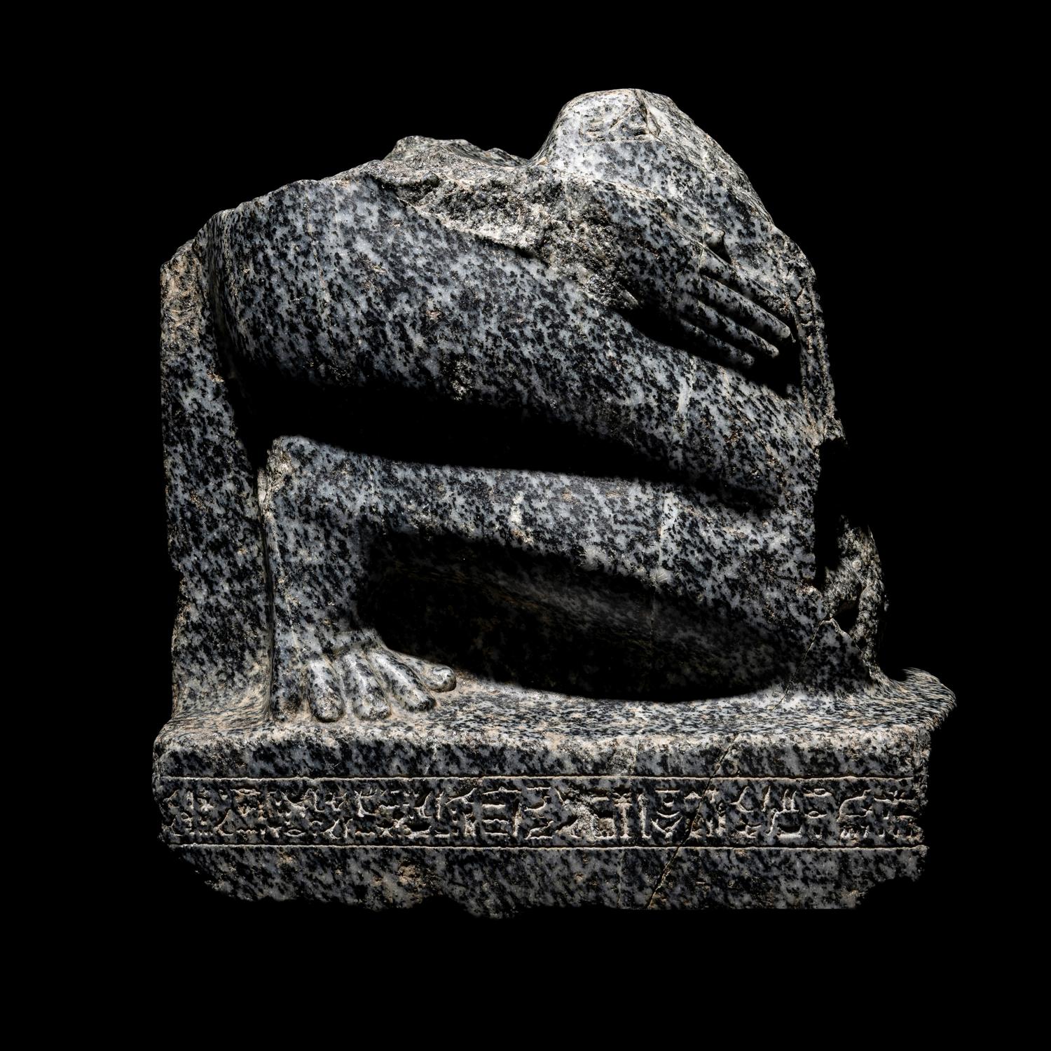 An Egyptian Gneiss Fragment of a Kneeling Figure