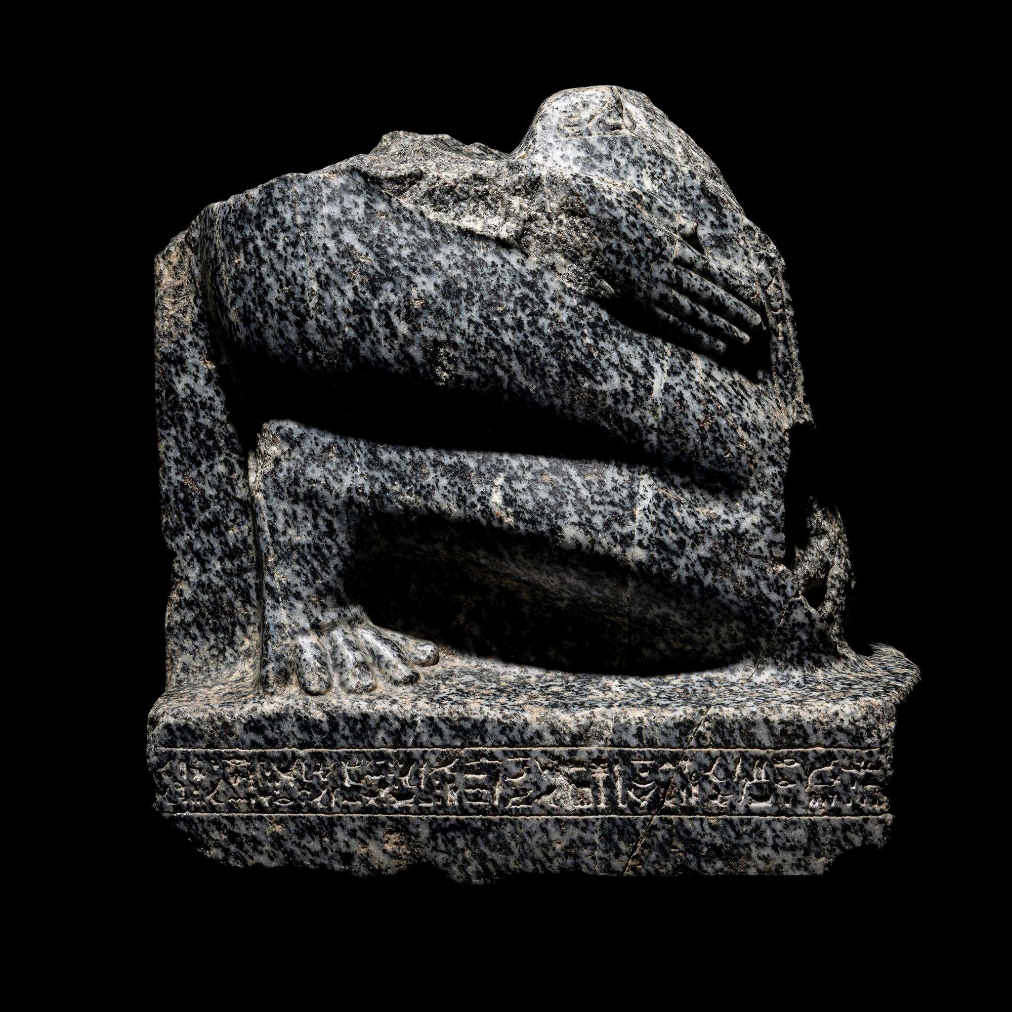 An Egyptian Gneiss Fragment of a Kneeling Figure