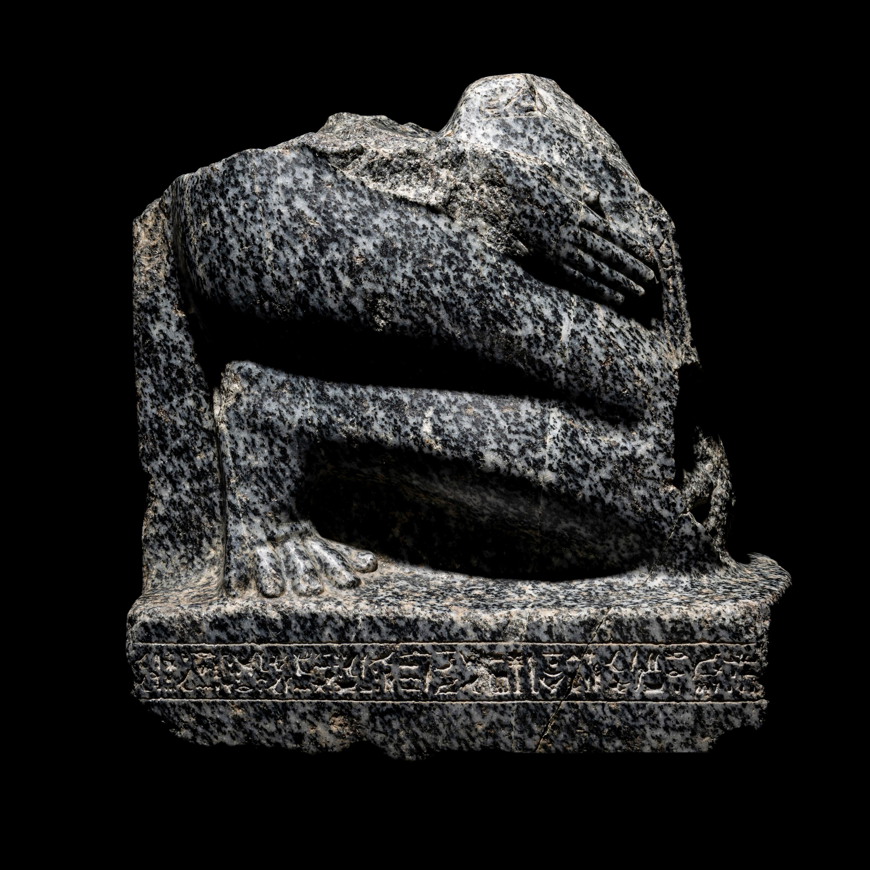 An Egyptian Gneiss Fragment of a Kneeling Figure