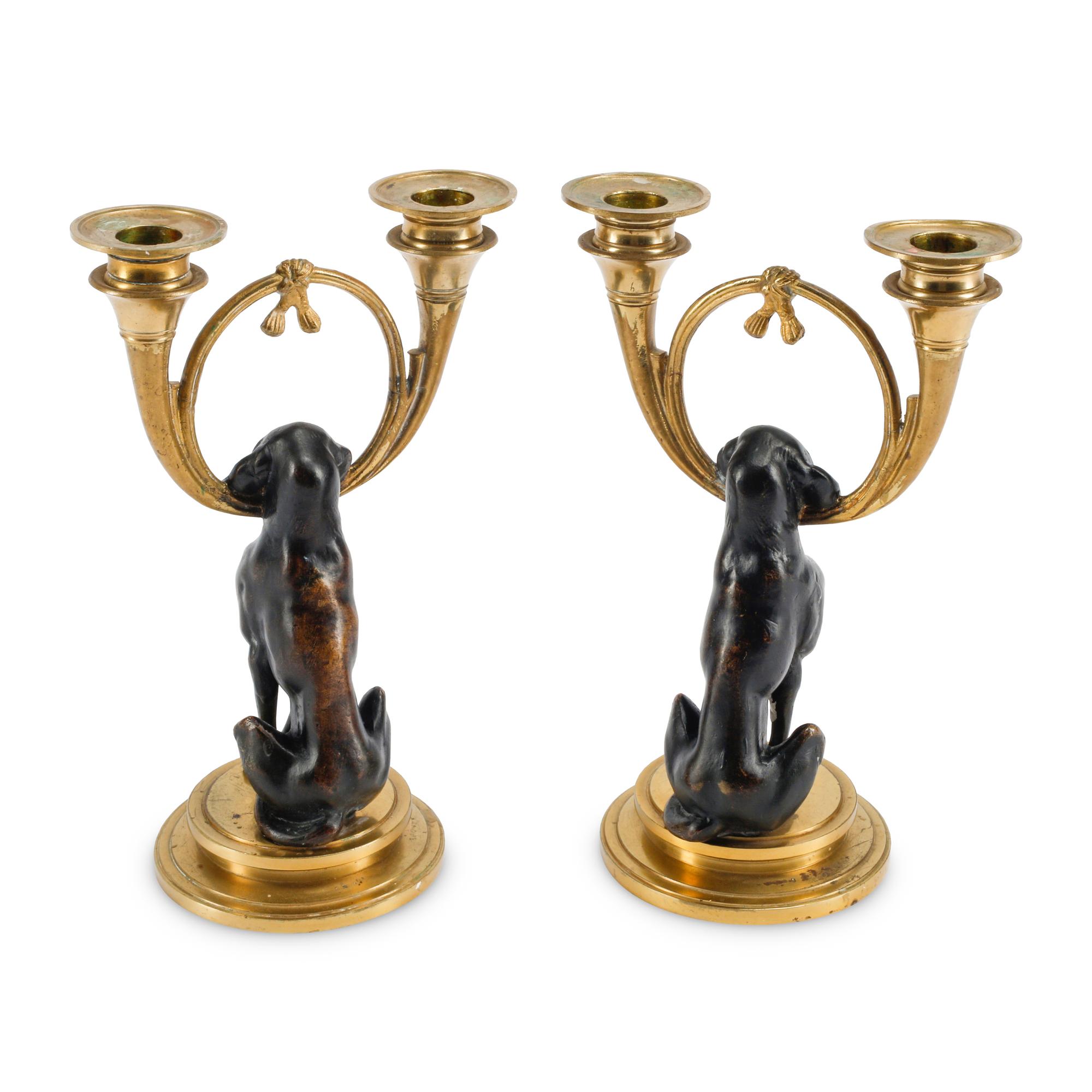 A Pair of Gilt and Patinated Bronze Dog Motif Two-Light Candelabra