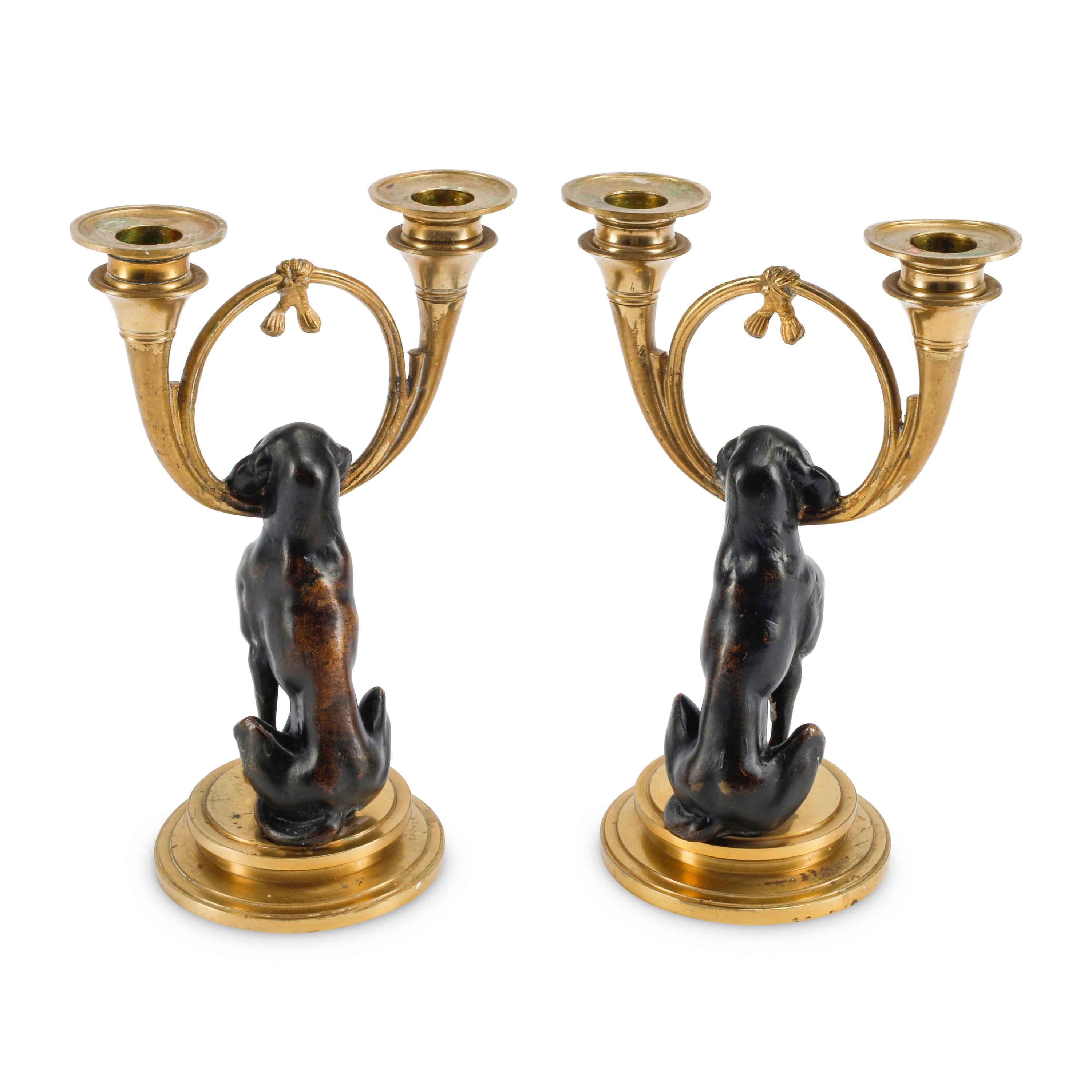A Pair of Gilt and Patinated Bronze Dog Motif Two-Light Candelabra